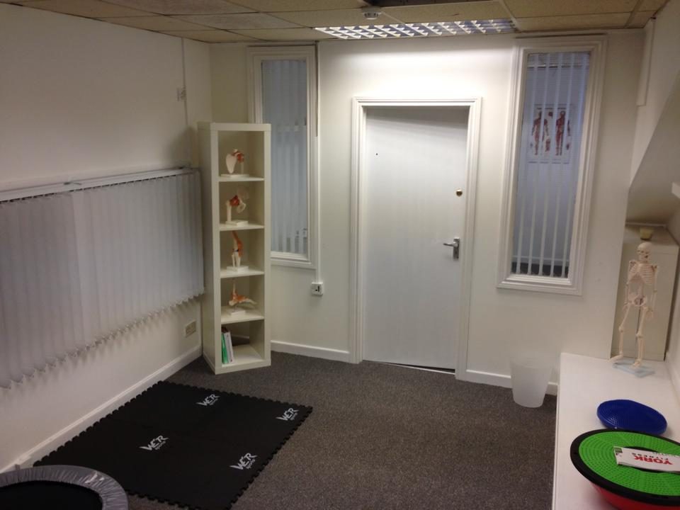 Derry Physio treatment room with exercise mats and anatomy models